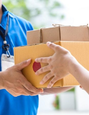 Woman hand accepting a delivery of boxes from deliveryman